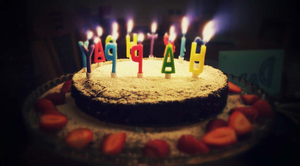 cake round Happy Birthday cake with lighted candles dessert